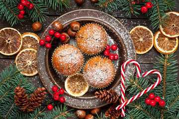 Christmas vanilla  delicious muffins served on ceramic plate. Sprinkled with powder sugar