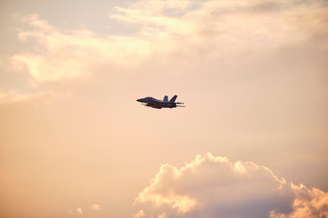 Australian Air Force fighter jet flying through Brisbane at sunset