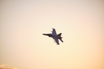 Australian Air Force fighter jet flying through Brisbane at sunset