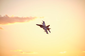 Australian Air Force fighter jet flying through Brisbane at sunset