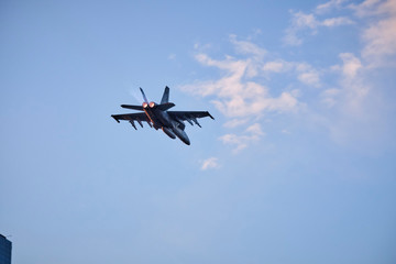 Australian Air Force fighter jet flying through Brisbane at sunset