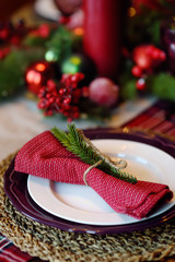 Christmas table set with wreath and red candles. Eve Xmas.