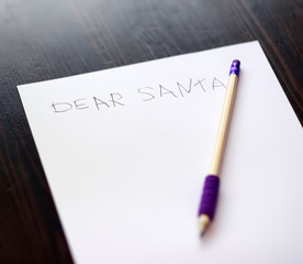 Child writing the letter to Santa. Kid dreams of a gift that he can receive.