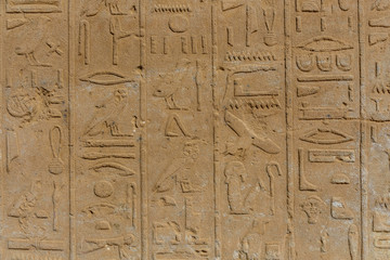 Fototapeta na wymiar Egyptian ancient hieroglyphs on the stone wall
