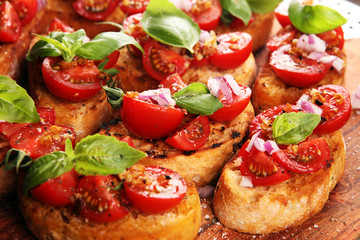 fresh tomato bruschetta. italian food appetizer with basil on table