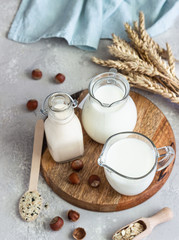 Alternative types of milks in glass bottles. Vegan nondairy milk. Assortment of organic vegan...
