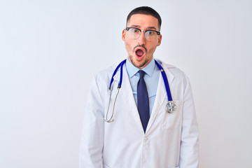 Young doctor man wearing stethoscope over isolated background In shock face, looking skeptical and sarcastic, surprised with open mouth