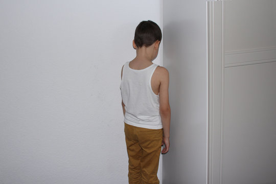 punished for a bad deed the boy stands in the corner, his back, educational concept