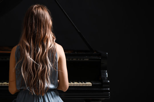 Young Woman Playing Grand Piano At The Concert