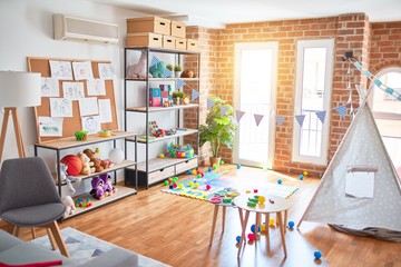 Picture of preschool playroom with colorful furniture, and toys around empty kindergarten