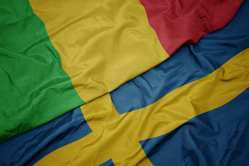 waving colorful flag of sweden and national flag of mali.