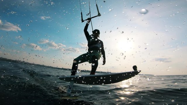 A person on kiteboard on water.
