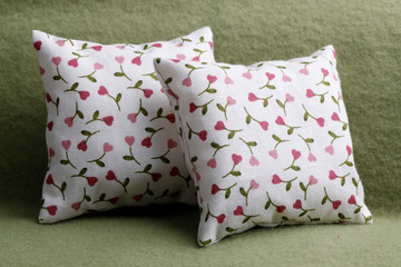 Two cushions with little hearts on the sofa