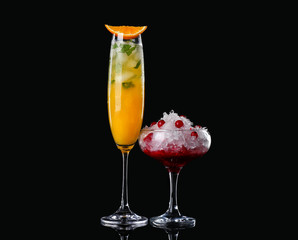 Different tasty cocktails on dark background