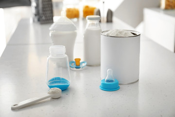 Baby milk formula on table in kitchen