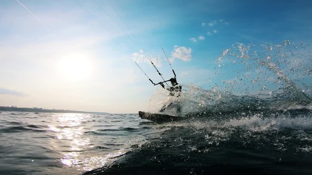 One man rides a kiteboard while training on water.