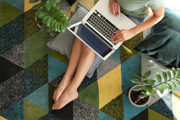 Young woman working on laptop at home