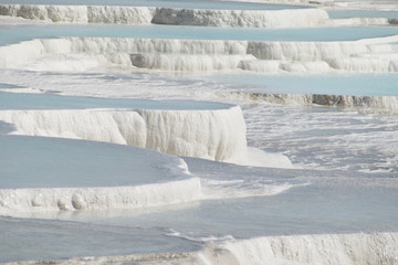 Pamukkale in Turkey is known for its mineral-rich thermal waters flowing down white travertine terraces. Pamukkale is nicknamed the cotton castle because of its white appearance.