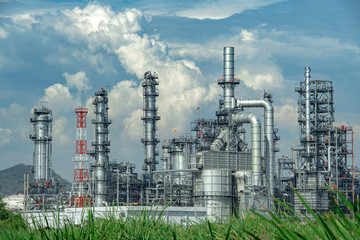 Fototapeta na wymiar Close-up view Oil and gas industrial refinery zone,Detail of equipment oil pipeline steel with valve from large oil storage tank at cloudy sky. -image
