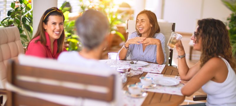 Young beautiful girl smiling happy and confident sitting dinking cup of coffee at terrace