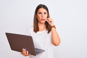 Beautiful young woman working using computer laptop over white background mouth and lips shut as...