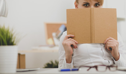 Fototapeta premium Portrait of businesswoman sitting at desk with a laptop