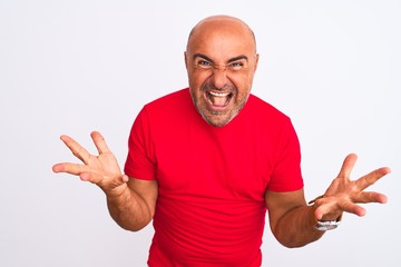 Fototapeta premium Middle age handsome man wearing red casual t-shirt standing over isolated white background celebrating crazy and amazed for success with arms raised and open eyes screaming excited. Winner concept