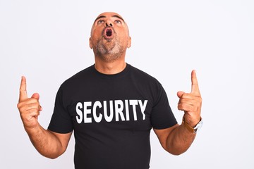 Middle age safeguard man wearing security uniform standing over isolated white background amazed...