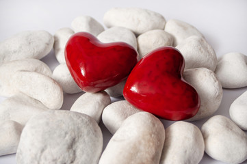 Obraz premium Abstract Background of white stones with two red hearts