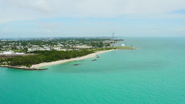 Aerial of Southernmost point of United States in Key West, paradise ocean coast of Florida, deep turquoise water, travel around US