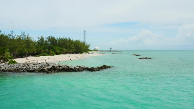 Aerial of Southernmost point of United States in Key West, paradise ocean coast of Florida, deep turquoise water, travel around US