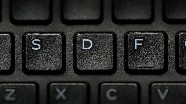Keyboard Letters closeup macro. Camera handheld and moves fast between alphabet..