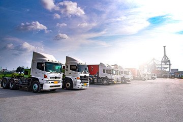 Fototapeta premium Logistyka przemysłowa i transport ciężarówki w stoczni kontenerowej dla logistyki i Cargo o zachodzie słońca