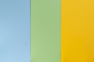 Yelllow green blue color paper background. Geometric flat composition. Empty space on monochrome...