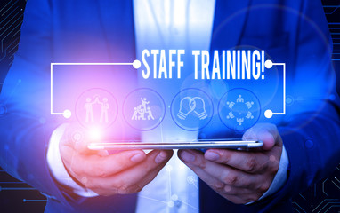 Text sign showing Staff Training. Business photo text learn specific knowledge improve perforanalysisce in current roles Male human wear formal work suit presenting presentation using smart device