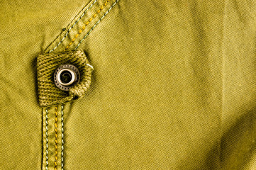 clothing items stonewashed cotton fabric texture with seams, clasps, buttons and rivets, macro