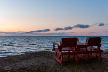 Fototapeta na wymiar two chairs on the beach over looking Lake Superior in Michigan's Upper Peninsula