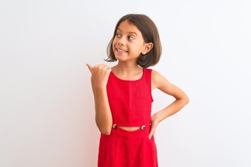 Young beautiful child girl wearing red casual dress standing over isolated white background smiling...