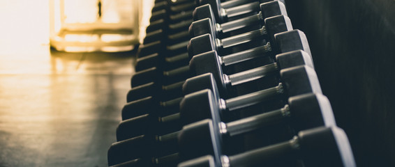 Dumbbells in many sizes, weights Set for exercising in the fitness center, exercise concept, health concept, close-up images.