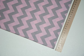 Pink fabric with a zigzag pattern on the table. Textiles, krupanj plan photo.