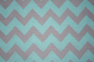 Green textile, fabric with a zigzag pattern, close-up photo.