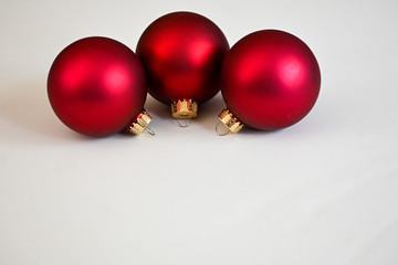 Red Christmas balls on white board