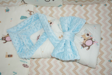 Beige bed linen set for a newborn baby's cot. Beige textile with zigzags and a pattern of bears....