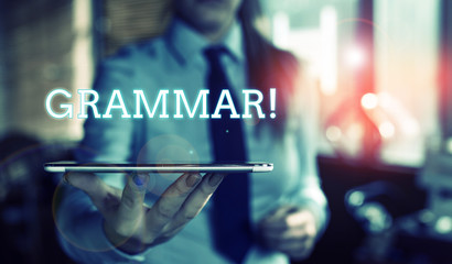 Word writing text Grammar. Business photo showcasing whole system structure language syntax and morphology Blurred woman in the background pointing with finger in empty space