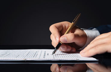 Lawyer, notary, attorney signs document