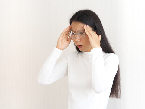 headache and neuropathic pain,haemophilus influenzae type B and ischemic stroke in asian woman, she touching head on isolated white background use for health care concept.