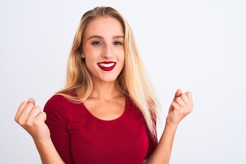 Young beautiful woman wearing red t-shirt standing over isolated white background screaming proud and celebrating victory and success very excited, cheering emotion