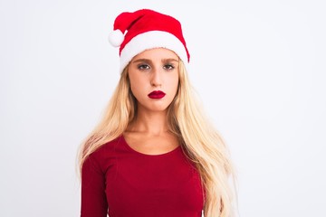Young beautiful woman wearing Christmas Santa hat over isolated white background depressed and worry for distress, crying angry and afraid. Sad expression.