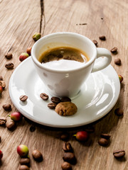 coffee beans behind cup of black coffee