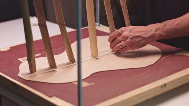 Professional luthier makes a guitar